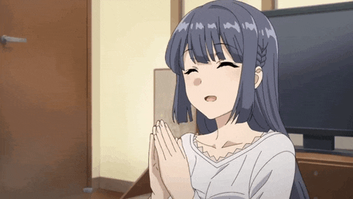 a girl with blue hair is praying in front of a television