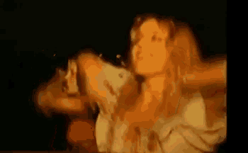 a blurry picture of a woman dancing in a dark room