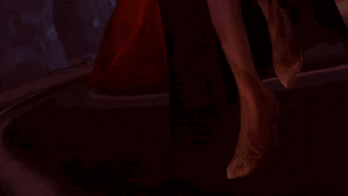 a woman with a purple face and white hair is wearing a red hood