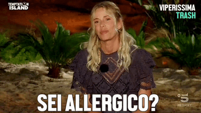 a woman says sei allergico in front of a temptation island sign