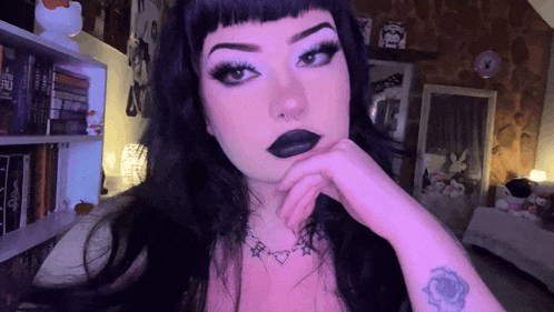 a woman with a tattoo on her wrist that says ' i love you '
