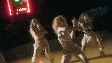 a group of young women are dancing on a basketball court .