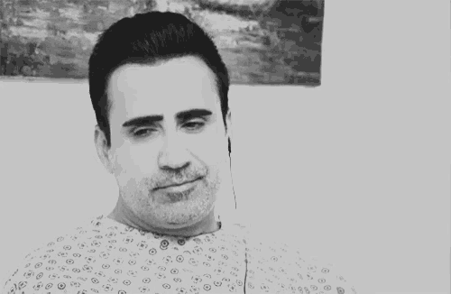 a man in a hospital gown with a smiley face on it