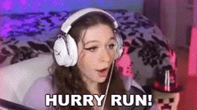 a girl wearing headphones is sitting in front of a computer screen and says `` hurry run '' .