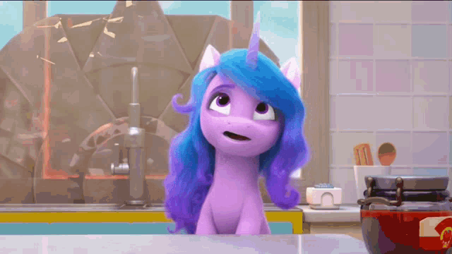 a purple pony with blue hair and a horn is sitting on a counter