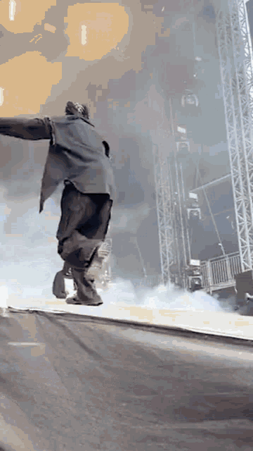 a man is jumping over a fence on a stage .