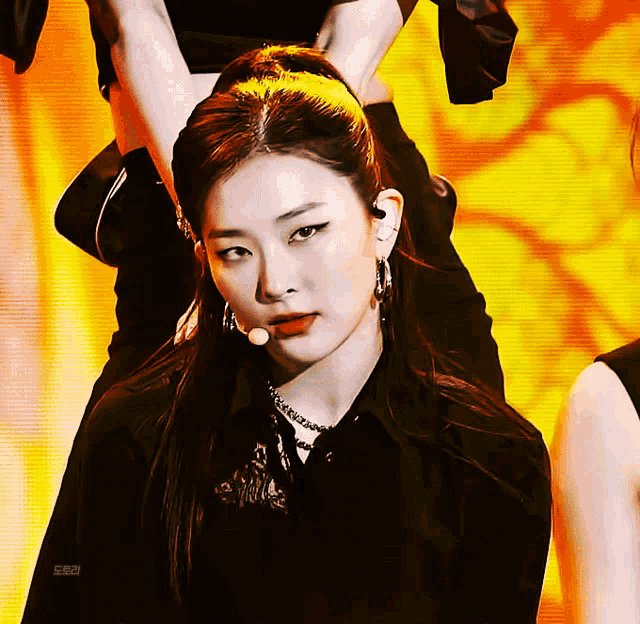 a close up of a woman 's face with a yellow background and the word seulgi on the bottom right