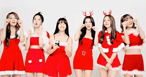 a group of young women dressed in santa claus costumes