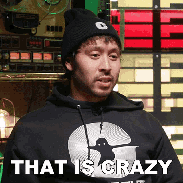 a man wearing a black shirt that says that is crazy on it