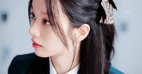 a close up of a woman 's face with a hair clip in her hair that says fendi