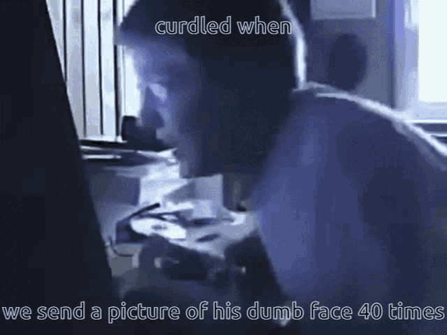 a man is looking at a computer screen with the caption cuddled when we send a picture of his dumb face 40 times ..