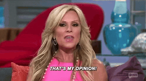 a woman is sitting on a couch and saying `` that 's my opinion '' .