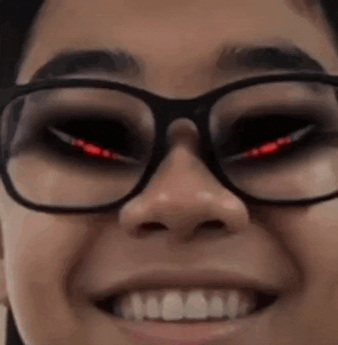 a close up of a person wearing glasses with evil eyes .