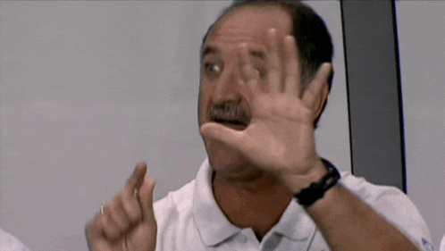 a man in a white shirt is making a funny face