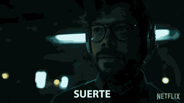 a man wearing glasses and headphones says suerte