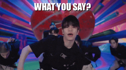 a man is dancing in front of a colorful background with the words " what you say " above him
