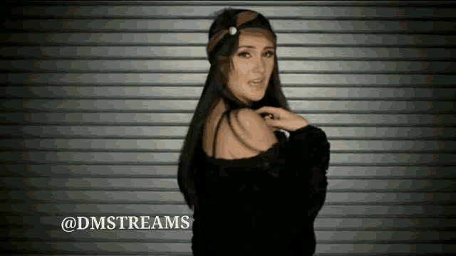 a woman is standing in front of a garage door with the words @dmstreams written on the bottom