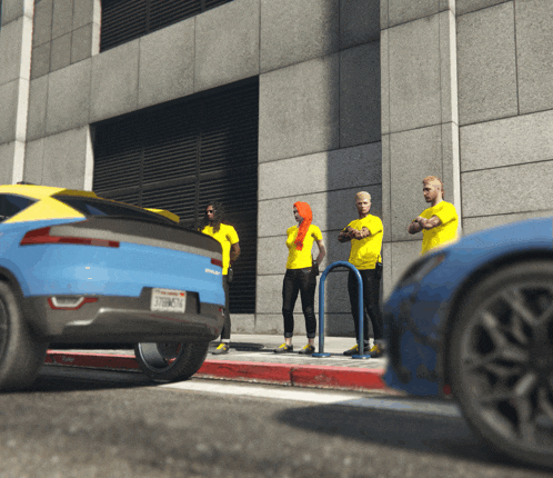 a group of people wearing yellow shirts are standing on a sidewalk next to a blue car
