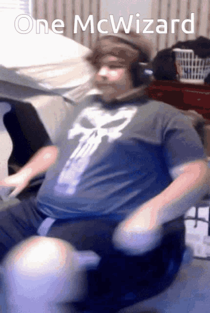 a man wearing headphones and a shirt that says one mcwizard on it
