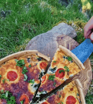 a slice of pizza is being taken out of a pie