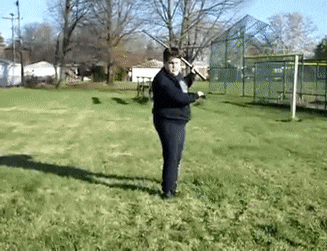 a man is holding a baseball bat in a field