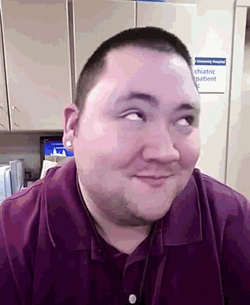 a man in a purple shirt is smiling in front of a sign that says " chiastic patient "