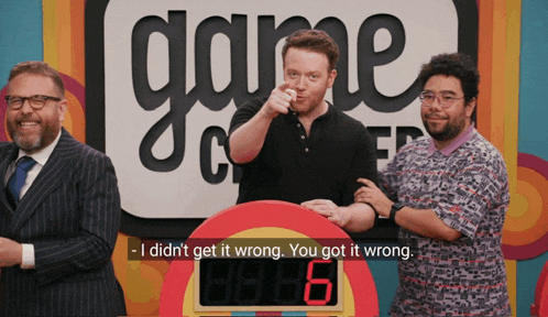 three men are standing in front of a sign that says game show