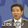 a man in a suit and tie is giving a speech in a microphone .