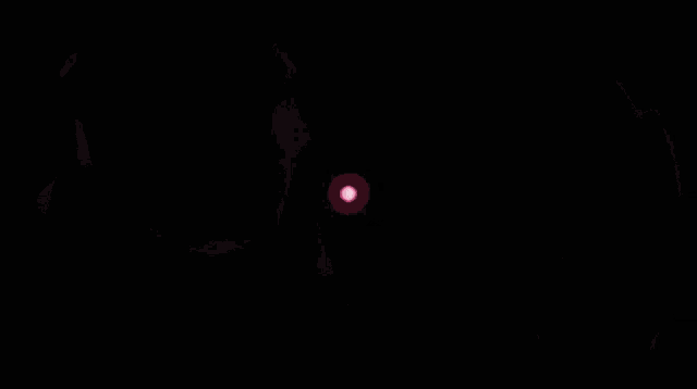 a close up of a person 's eye with a pink circle in the center
