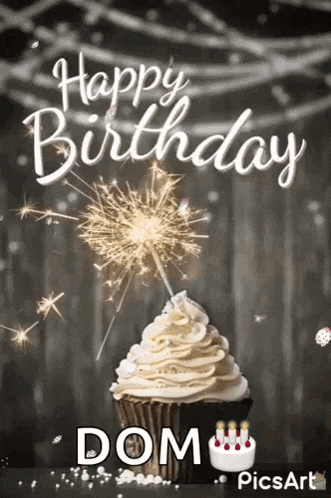 a happy birthday greeting card with a cupcake and a sparkler .