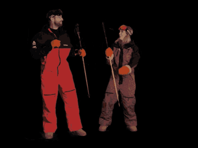 a man and a woman are standing next to each other with ski poles