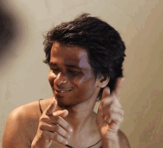 a man with blood on his face is smiling and giving a thumbs up sign