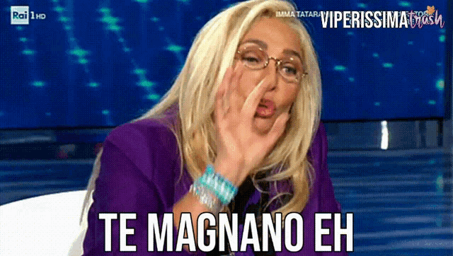 a woman wearing glasses and a purple jacket with the words te magnano eh