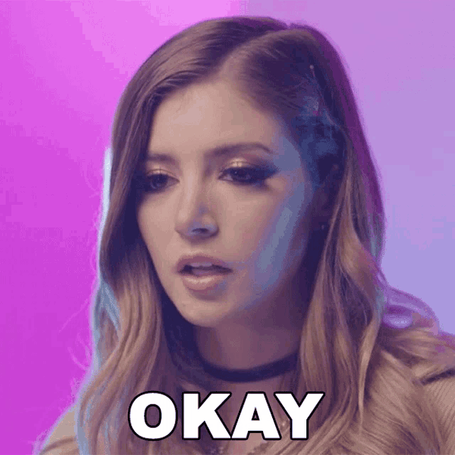 a woman is making a face and the word okay is on her face