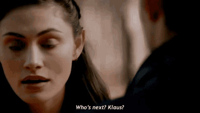 a woman is talking to a man and asking him who 's next ? klaus .