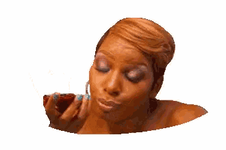 a woman is holding a red pepper in her hand and making a face .