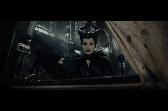 a woman with horns is looking at herself in the mirror