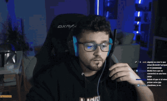 a man wearing glasses and headphones with the word marvel on his shirt