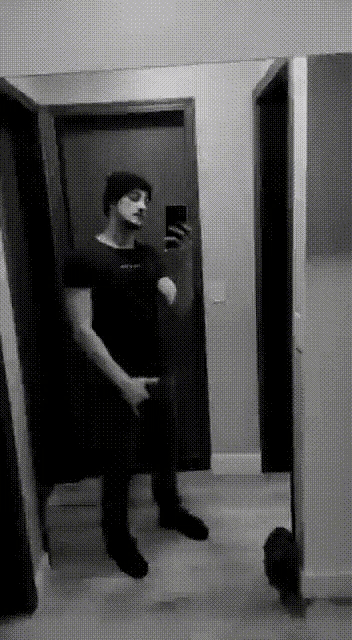 a black and white photo of a man taking a selfie