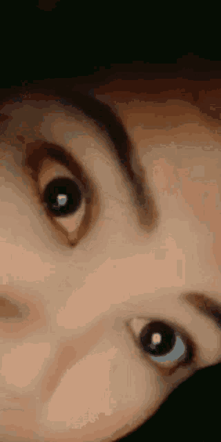 a close up of a person 's eyes with the letter p in the corner
