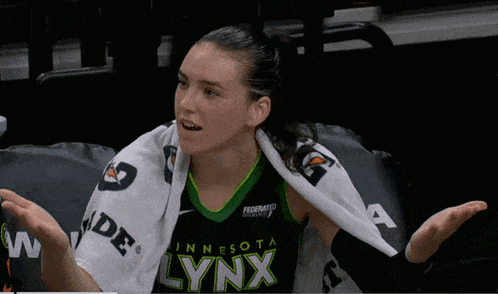 a woman wearing a minnesota lynx jersey