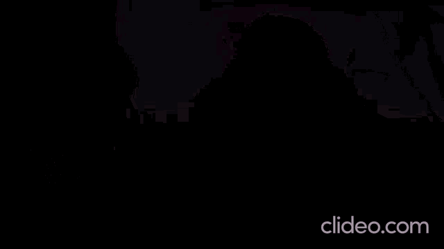 a close up of a woman 's face with the website clideo.com in the lower right corner