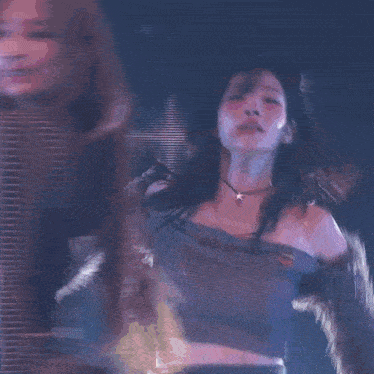 a blurry picture of a woman dancing with a pink light behind her