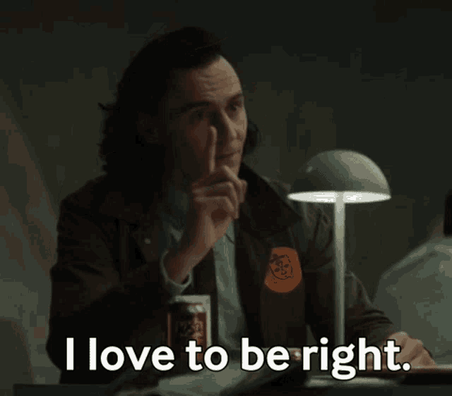 loki from marvel 's guardians of the galaxy is sitting at a desk with a can of soda and a lamp .