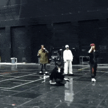 a group of people are standing in a dark room with a yellow sign that says ' emergency exit '