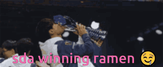 a man holding a trophy with the words sda winning ramen below