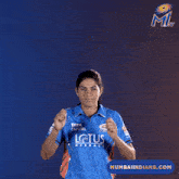 a woman wearing a blue jersey that says six on it