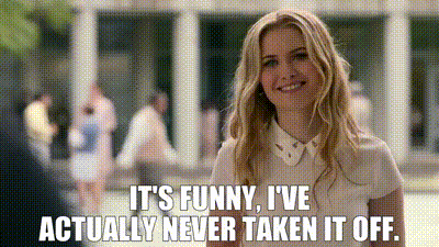 a woman is smiling and saying `` it 's funny , i 've actually never taken it off .