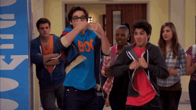a boy wearing a blue shirt that says boc