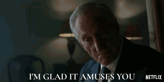 a man in a suit says i 'm glad it amuses you netflix